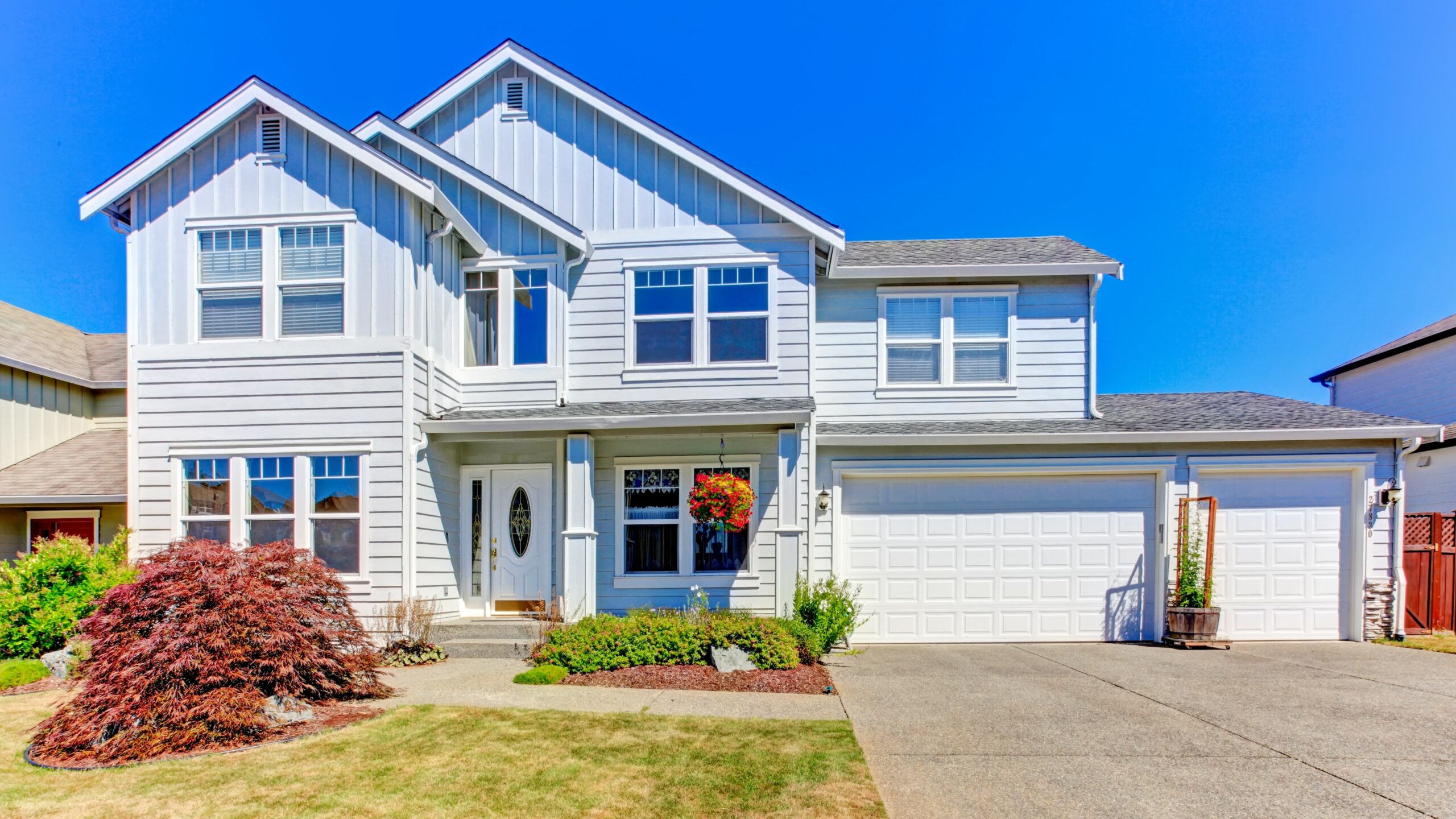 Nice new home exterior with bright blue siding and large garage door