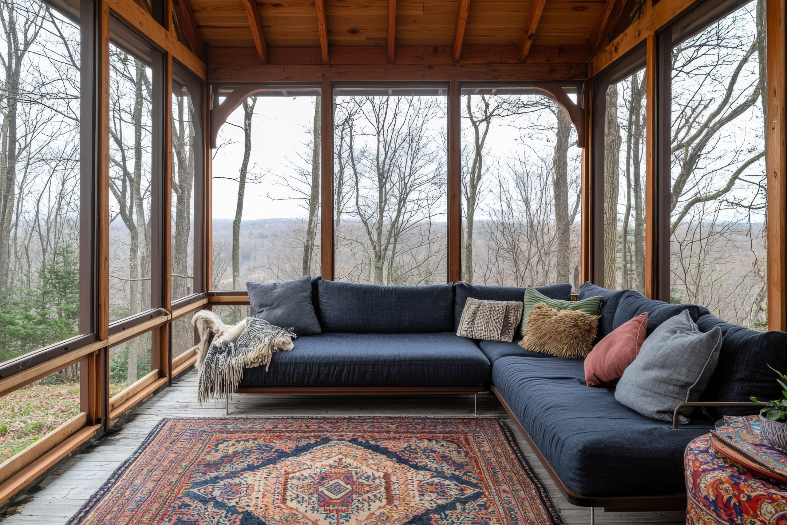 Wood patio enclosure with rug and blue couch