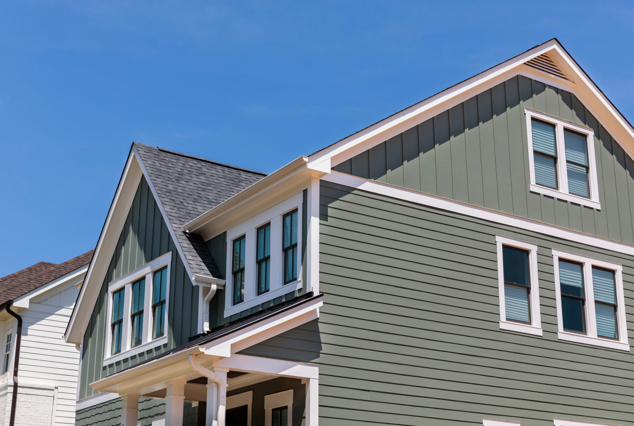 Side of house with sage green traditional lap siding
