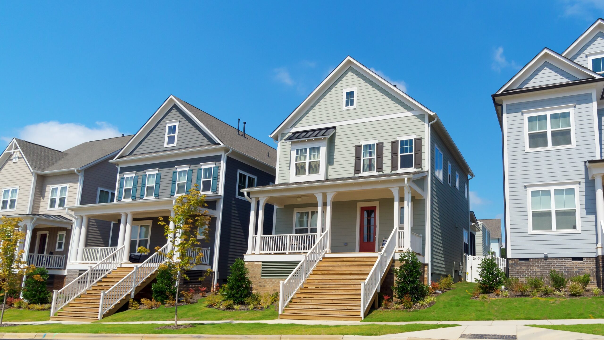 Line of newly built houses with nice siding and beautiful roofs
