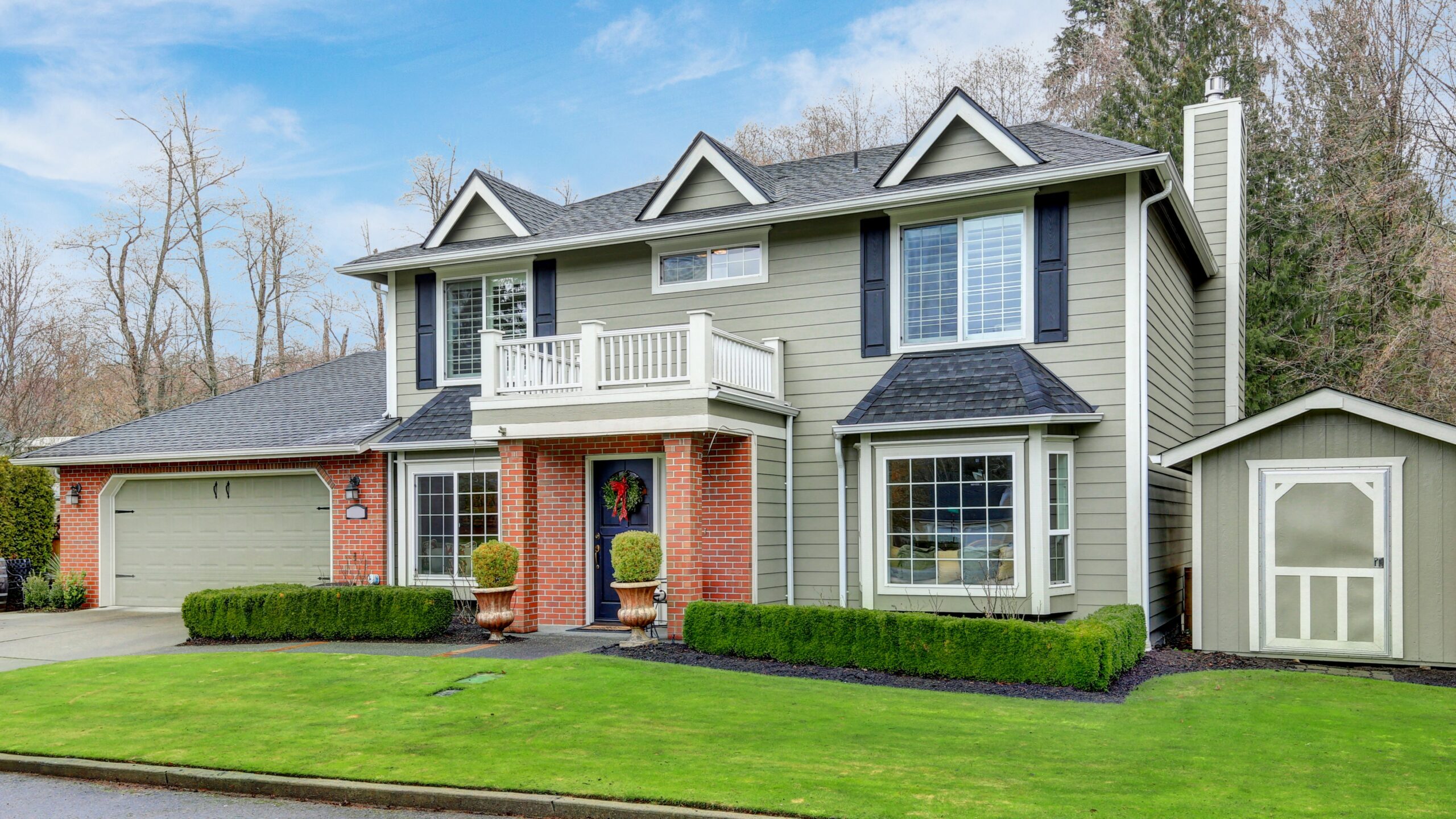 Exterior of beautiful new home with grey siding and new roof