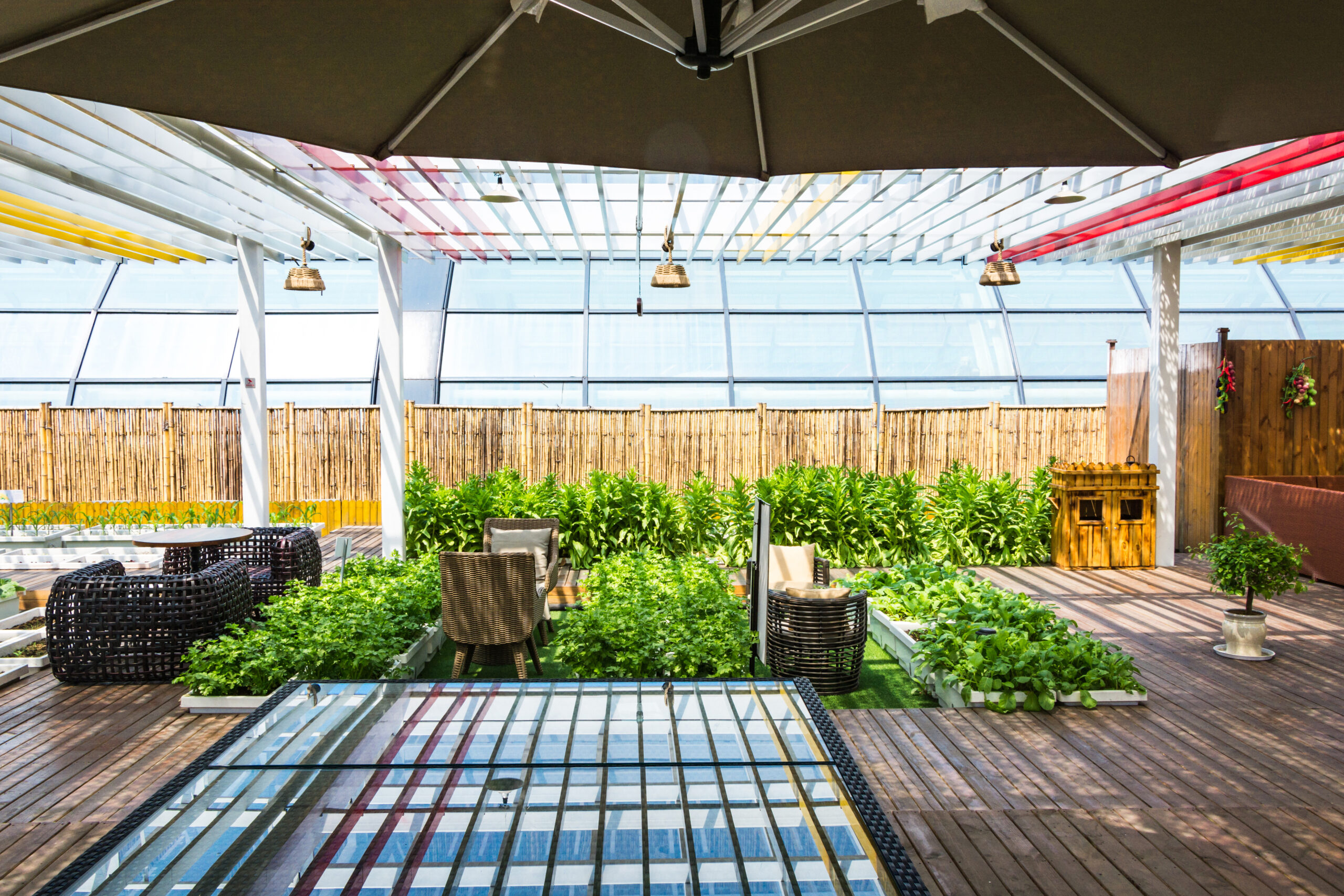 Patio enclosure outside of a yellow house with French doors