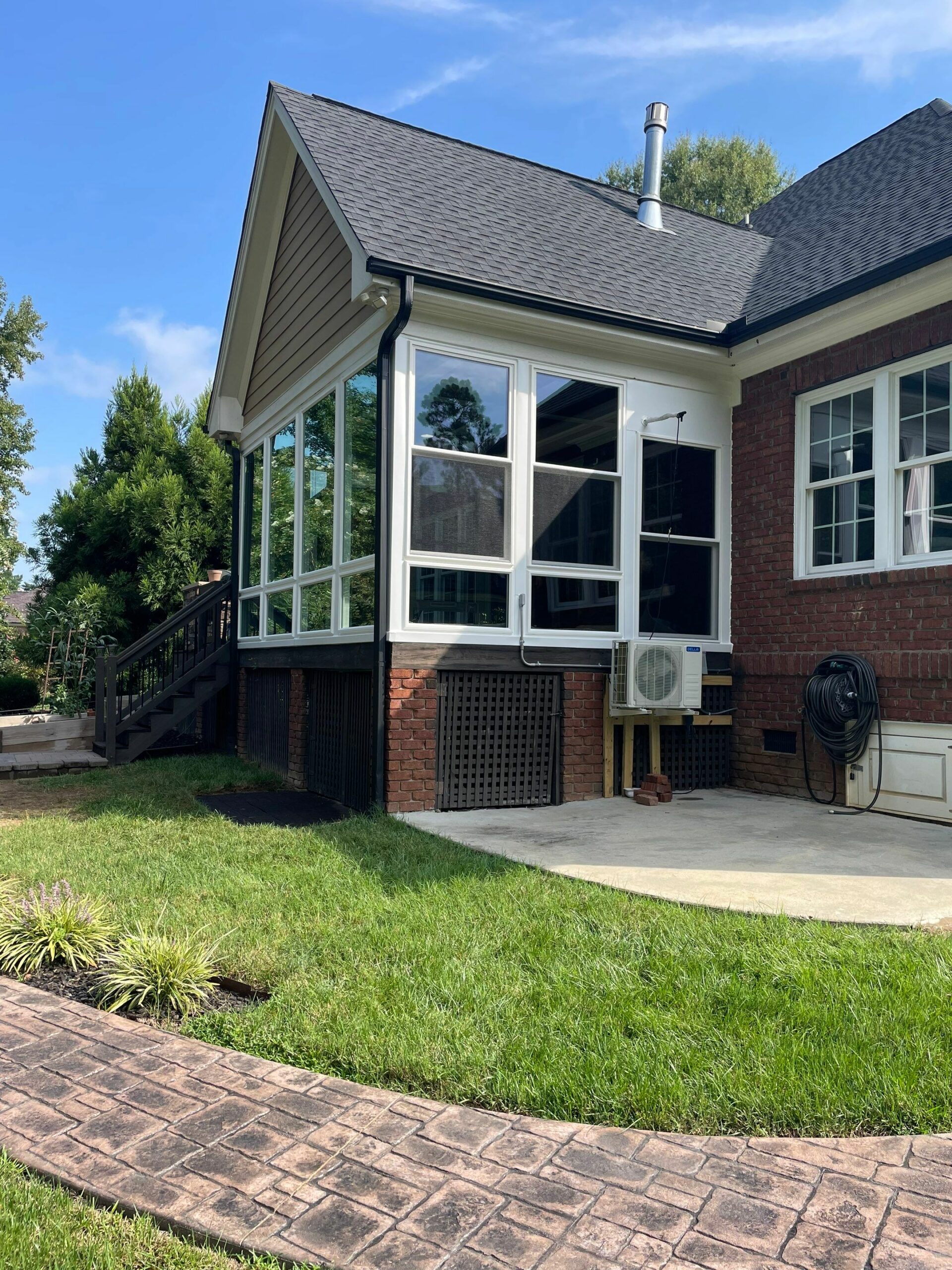 Sunroom conversion featuring Endure white picture and double-hung windows